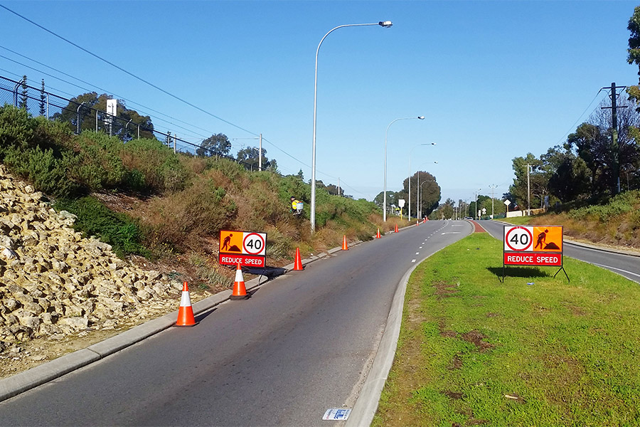 Weed control on council nature strip with required traffic signage