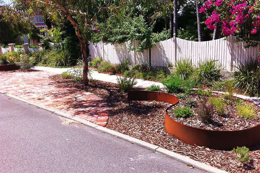 Waterwise verge garden in Perth with rusted metal planter